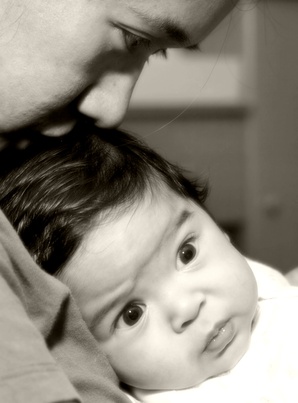 Mom kissing baby head