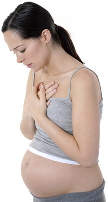 Pregnant woman holding chest