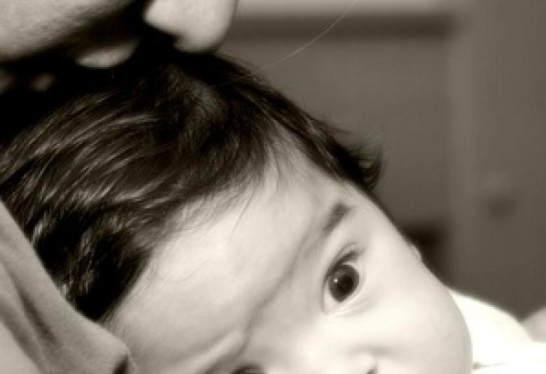 Mom kissing baby head