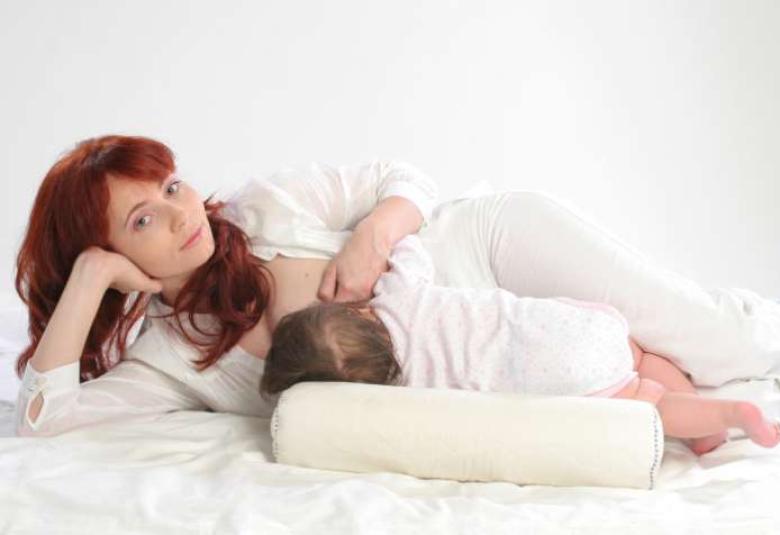 Woman on side breastfeeding