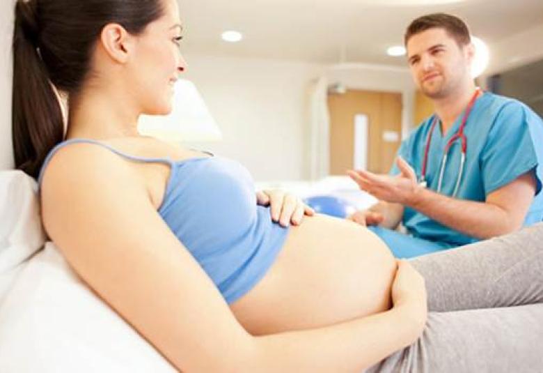 Pregnant woman with doctor