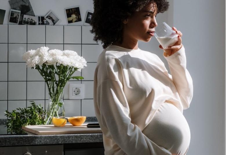 Pregnant woman holding drink