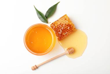 Honey in jar with honeycomb