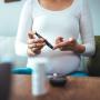 Pregnant woman checking blood glucose